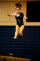 West Potomac's Monica Thompson jumps during her beam routine during a meet at West Potomac High School on January 3, 2011.