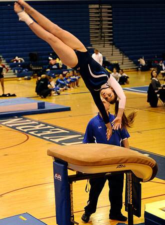 West Potomac's Marien Voorhees leaps onto the vault during a six-school meet at West Potomac High School on January 3, 2011. West Potomac placed second with a score of 124.025 points.