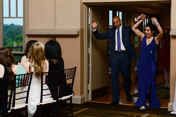 Alex's parents enter the hall.