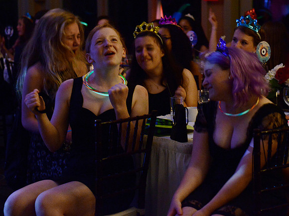 Belting out to a song.