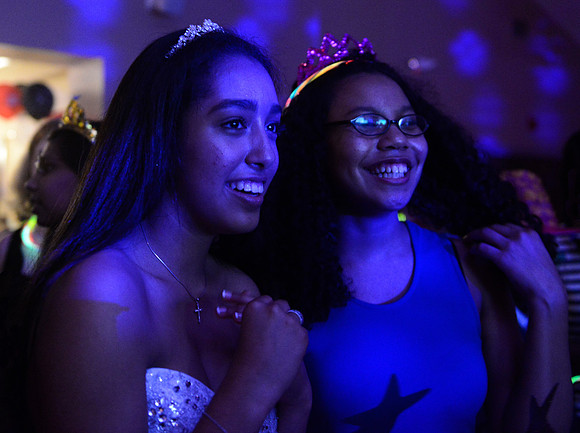 Alex and a friend watch a slideshow.