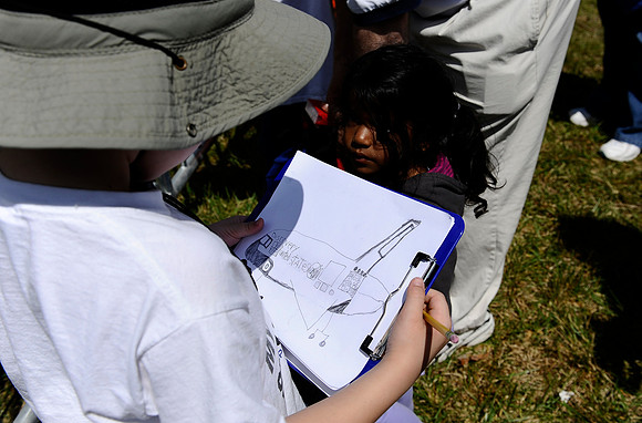 A young boy holds his drawing of the space shuttle Discovery at the Steven F. Udvar-Hazy Center on April 19, 2012.
