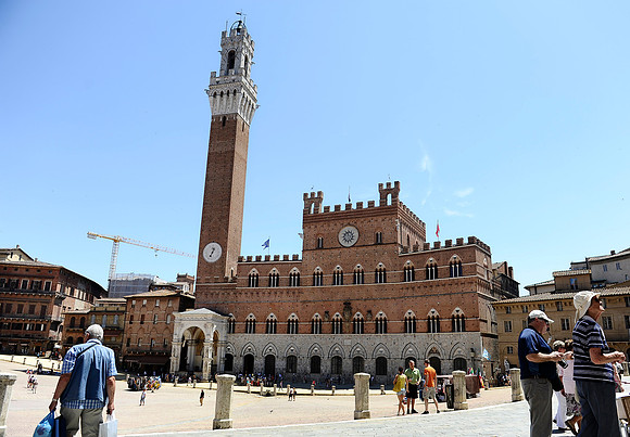 A view of the Piazza del Campo of Siena, Italy. The Palazzo Pubblico and the Torre del Mangia dominate the medieval square. Il Palio horse race is held in the shell-shaped plaza.July 4, 2012