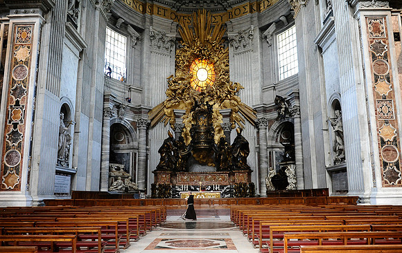 A priest walks in front of the "Cathedra Petri" in St. Peter's Basilica in the Vatican City.July 3, 2012